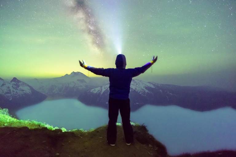 Nightscape Photos. LIFELIGHTLENS image of a man witnessing Northern Lights over Garibaldi Lake