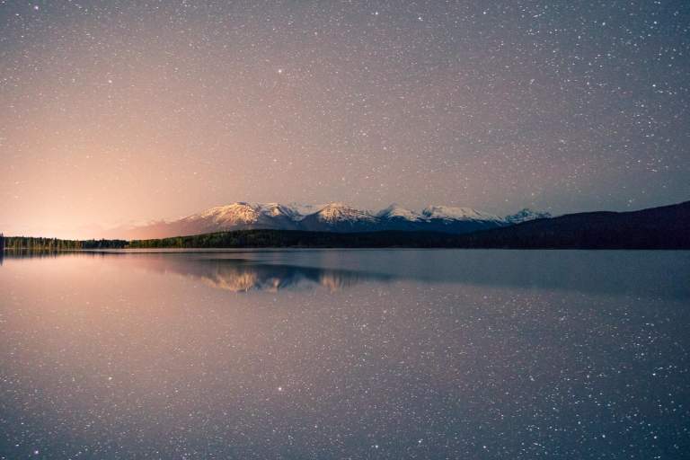 Nightscape Photos. LIFELIGHTLENS image of a the reflection of stars on a lake in Banff.