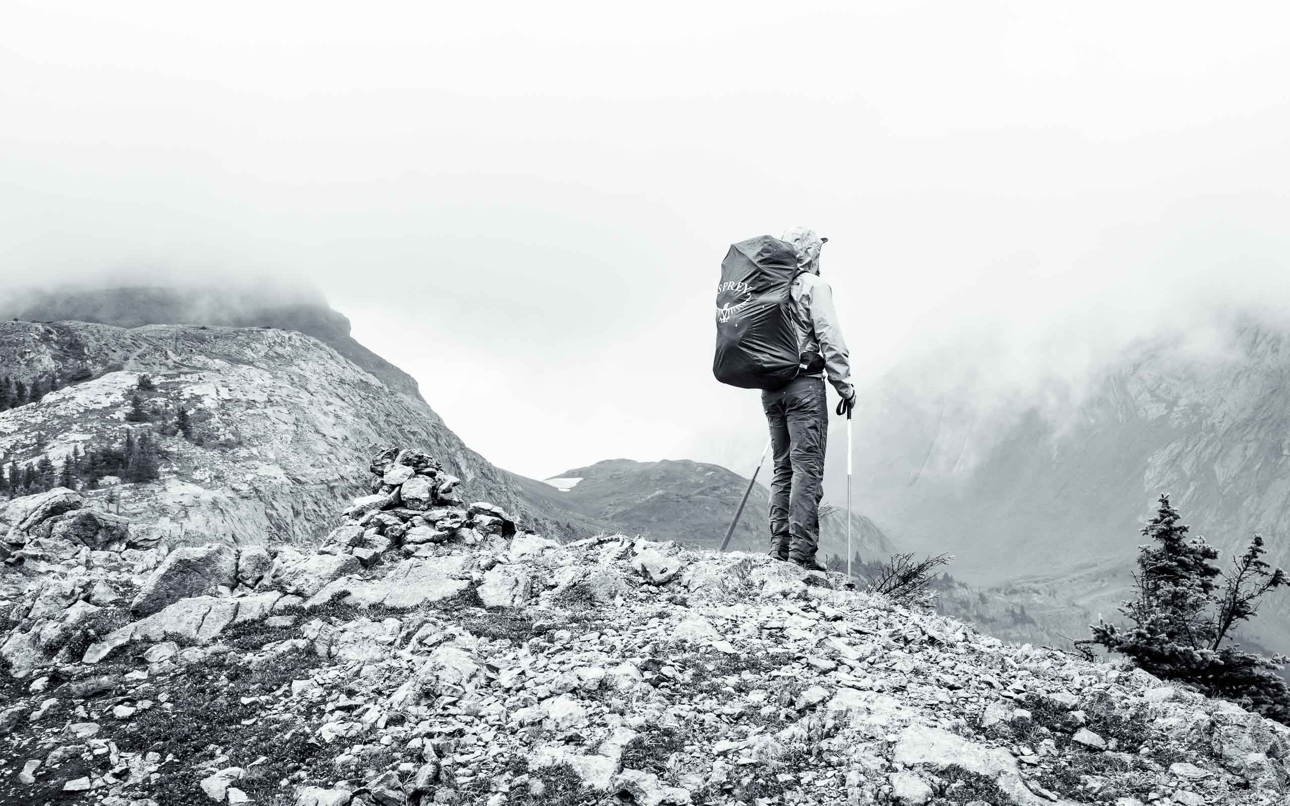 Marketing Image Content. Branding photography featuring a man wearing an Osprey backpack on a mountain top.