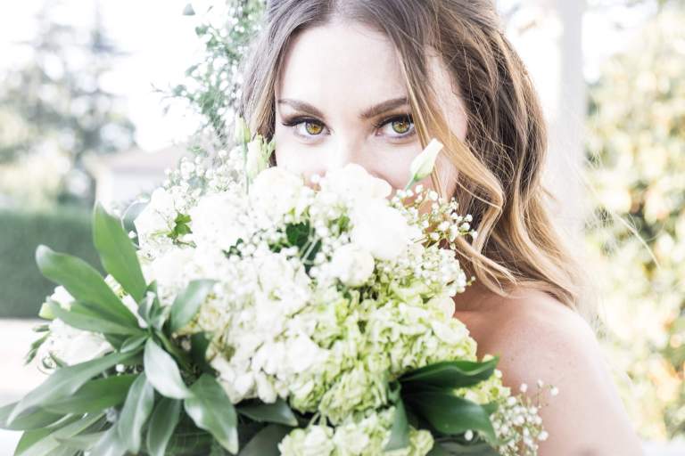 Wedding Photos. LIFELIGHTLENS image of a bride with her bouquet over her mouth