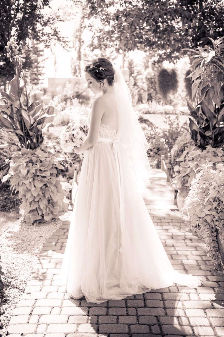 Wedding venue. LIFELIGHTLENS image of a bride standing by herself.
