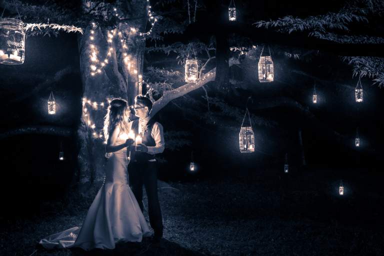Wedding ideas. LIFELIGHTLENS image of a couple surrounded by candles in the dark.