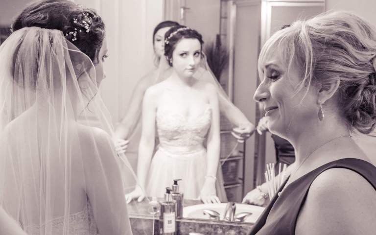 Wedding Photos. LIFELIGHTLENS image of a mother crying at the sight of her daughter as a bride.