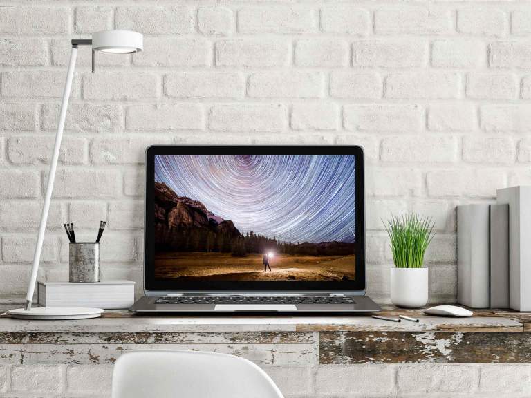 Device backgrounds. A picture of a workspace laptop with a hd photo background displayed.