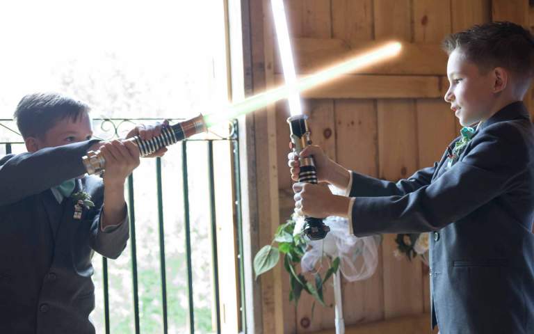 Wedding Theme. Children in the wedding party duel with lightsabers