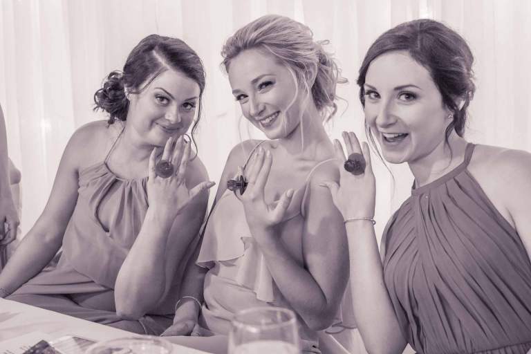 Wedding venue. The bride's sisters play with ring pop engagement rings